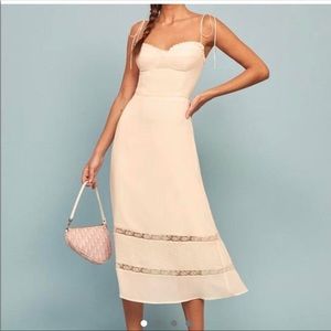 Reformation white/cream midi dress with lace details and tie straps.